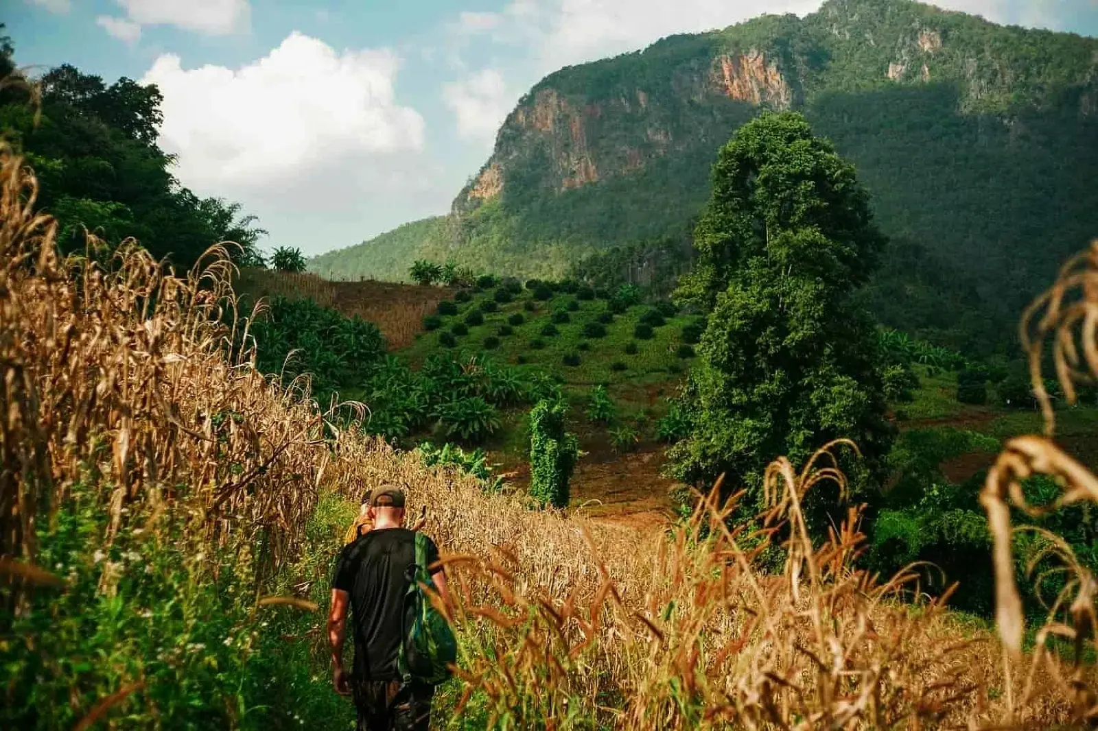 A traveler crossing a mountain landscape in Northern Thailand